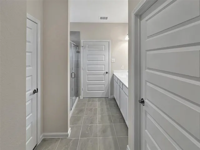 a bathroom with a double vanity sink a mirror and a shower