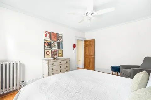 a bedroom with a bed dresser and a window