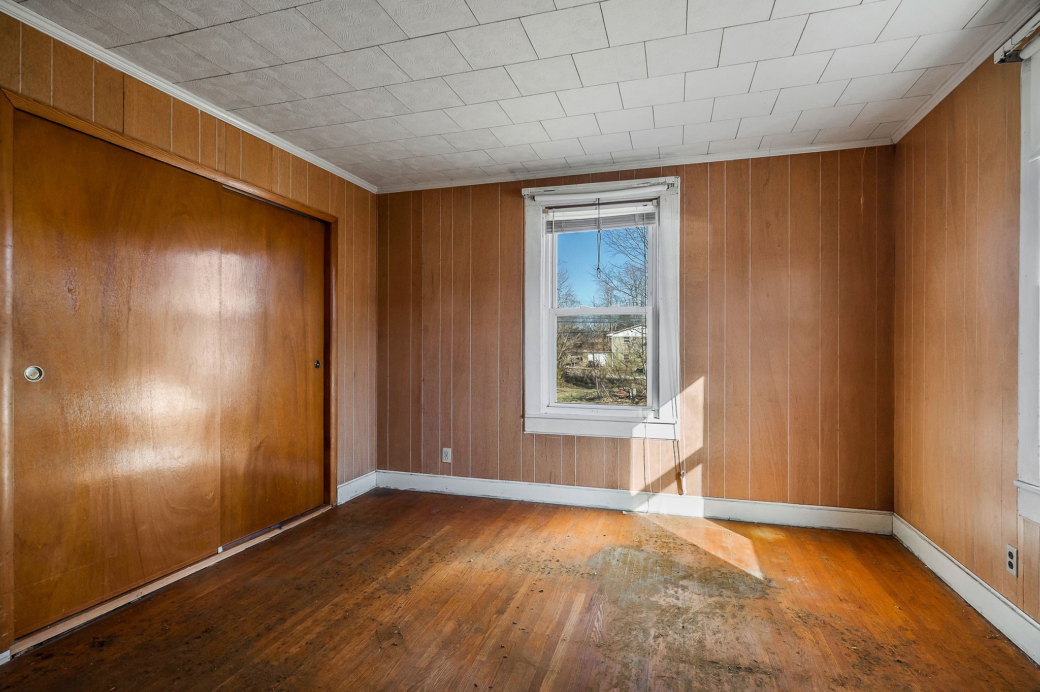 304 South Young Street Sparta, TN 38583 - Photo 13 of 20 an empty room with wooden floor and windows with curtains
