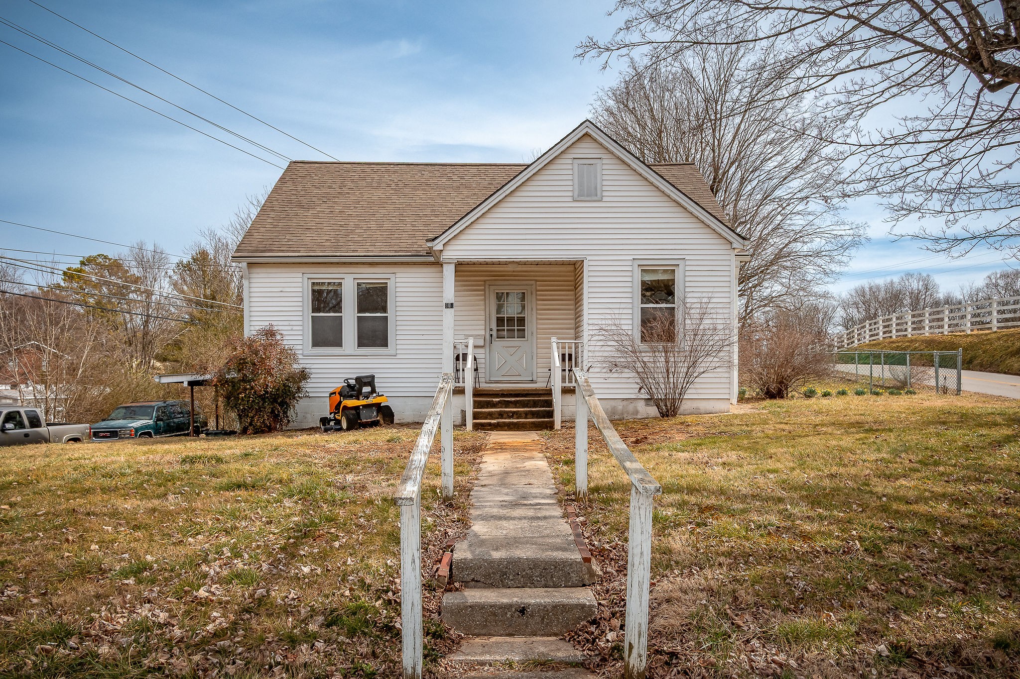 304 South Young Street Sparta, TN 38583 - Photo 2 of 20 a view of a house with wooden walls and a yard