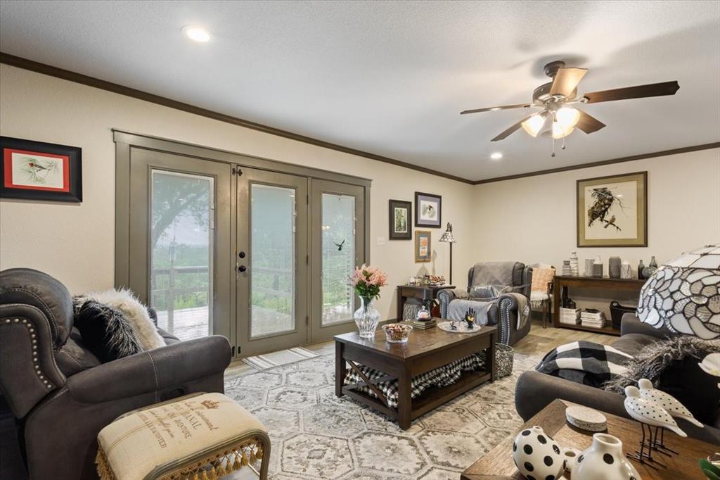 649 Wedgewood Drive China Spring, TX 76633 - Photo 2 of 39 Living area with crown molding, french doors, recessed lighting, and a ceiling fan