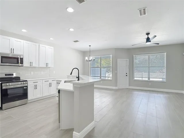 a kitchen with stainless steel appliances refrigerator and cabinets
