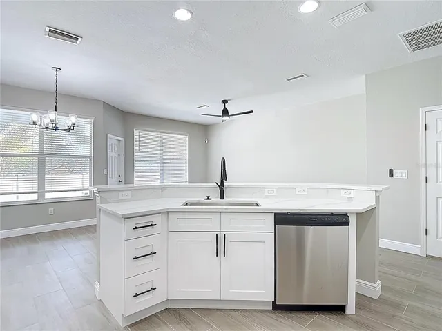 a kitchen with stainless steel appliances a refrigerator a sink a stove and cabinets
