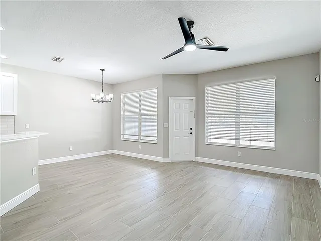 an empty room with wooden floor