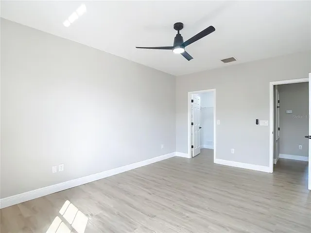 a view of an empty room with wooden floor