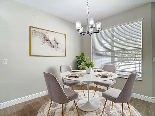 a view of a dining room with furniture window and wooden floor
