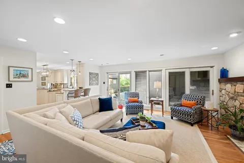 a kitchen with granite countertop a sink cabinets stainless steel appliances and a window