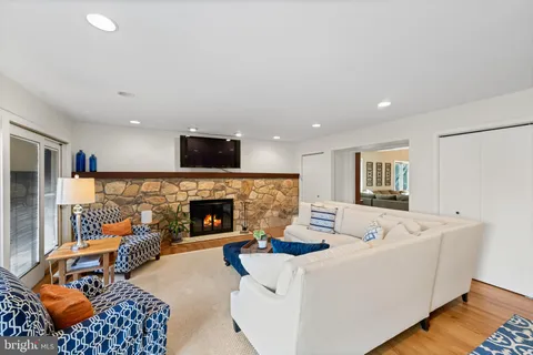 a view of a dining room and livingroom with furniture wooden floor a chandelier