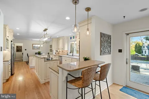 a view of a dining room with furniture wooden floor and chandelier