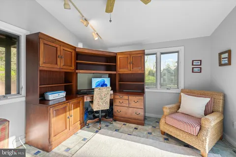 a spacious bathroom with a granite countertop sink a mirror and a toilet