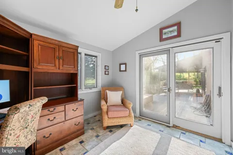 a bathroom with a large tub sink and mirror
