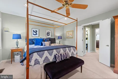 a bedroom with a bed and a desk