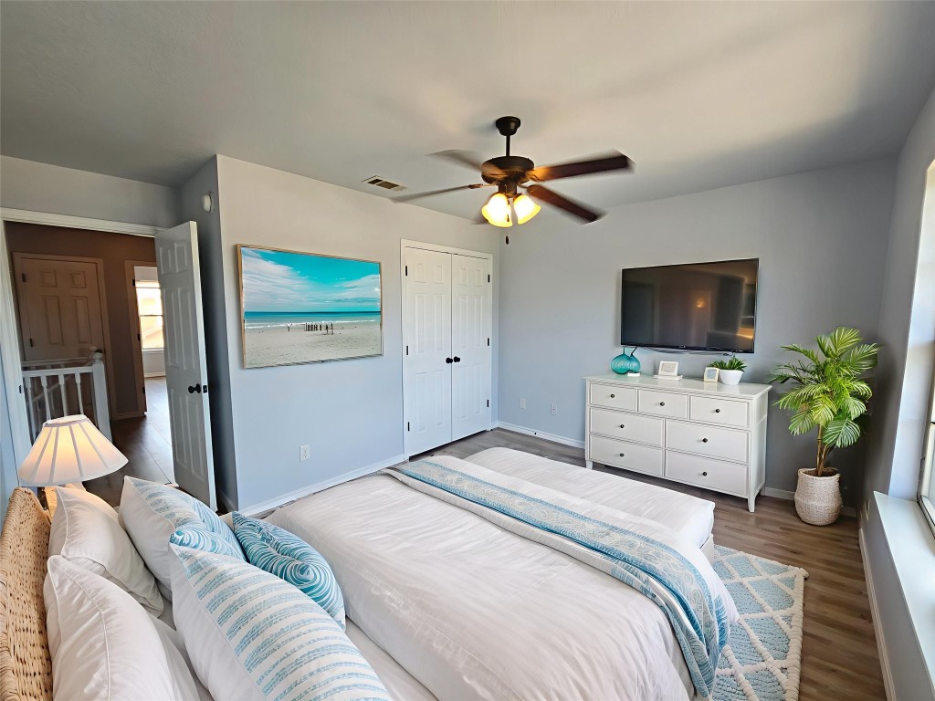 154 Sierra Rose Loop Georgetown, TX 78626 - Photo 8 of 13 a bedroom with a bed furniture and a flat screen tv