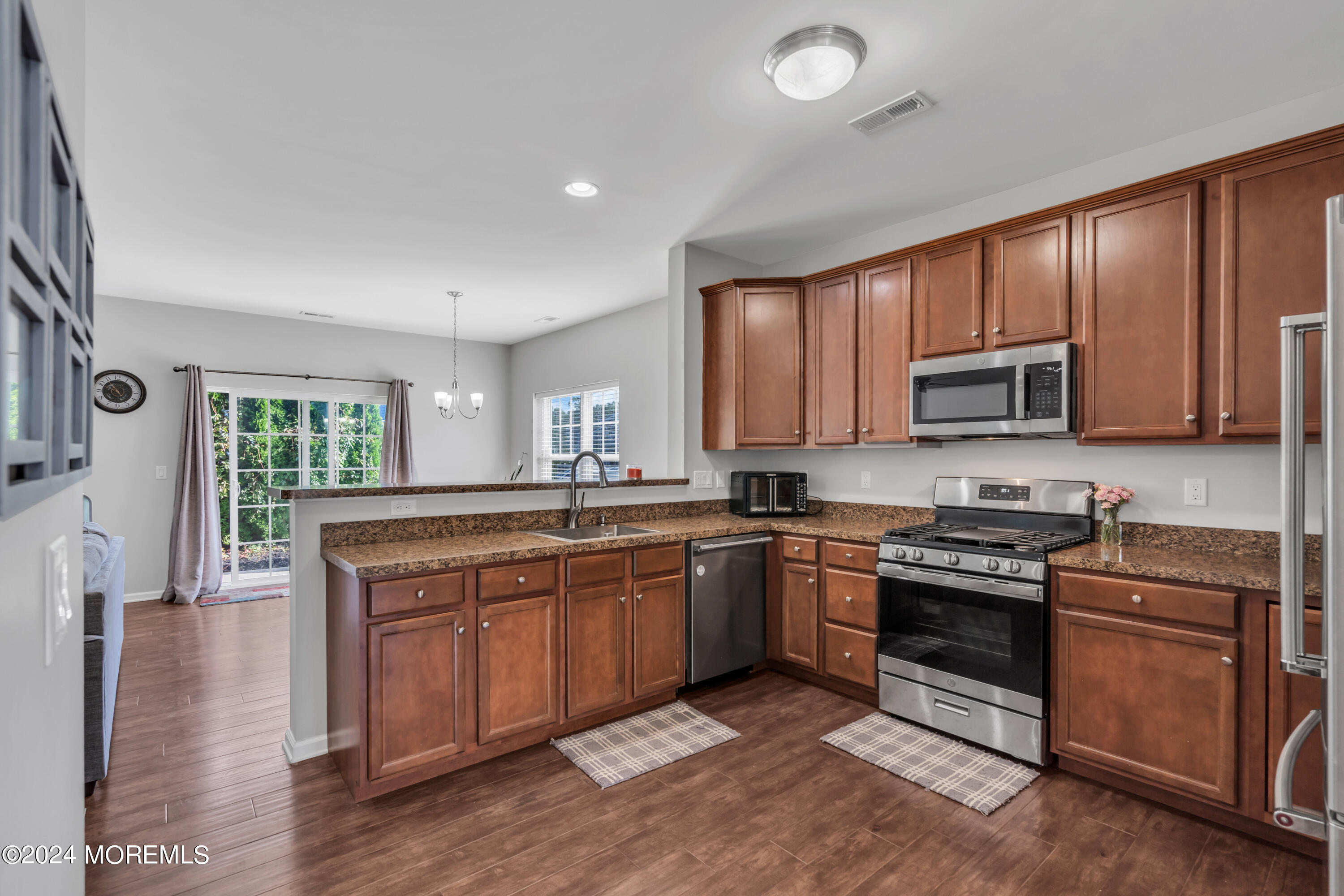 36 Rockingham Way Manchester Township, NJ 08759 - Photo 13 of 40 a kitchen with stainless steel appliances granite countertop wooden cabinets a stove a sink and dishwasher with wooden floor