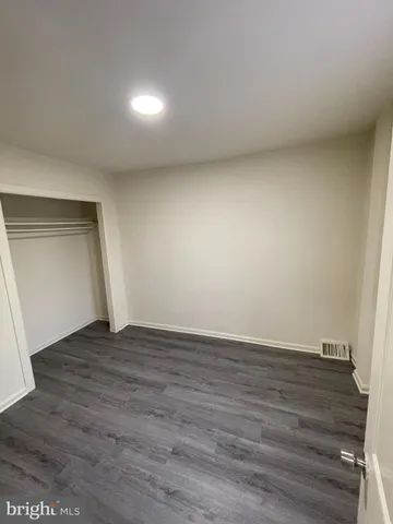 a view of an empty room and wooden floor