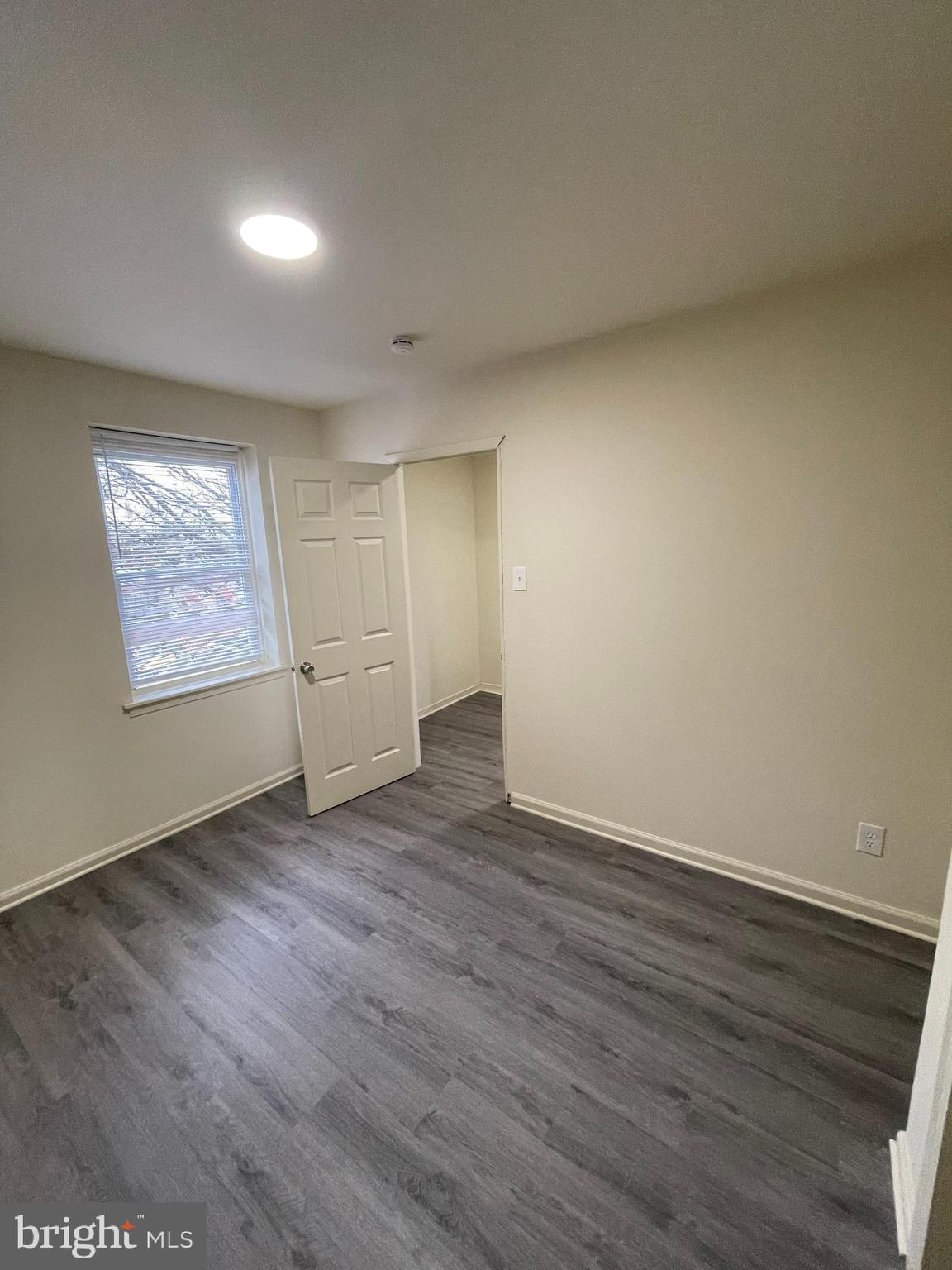 2441 North 5th Street Philadelphia, PA 19133 - Photo 15 of 18 a view of an empty room with wooden floor and a window