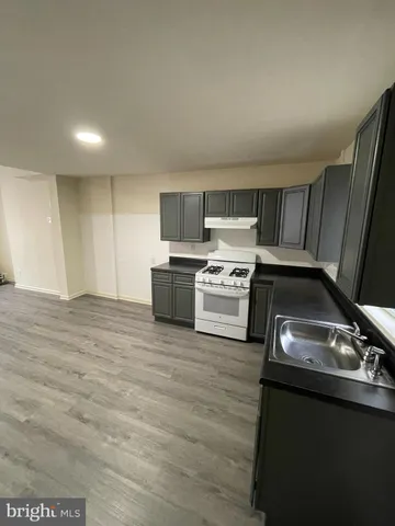 a kitchen with a stove a microwave and a sink