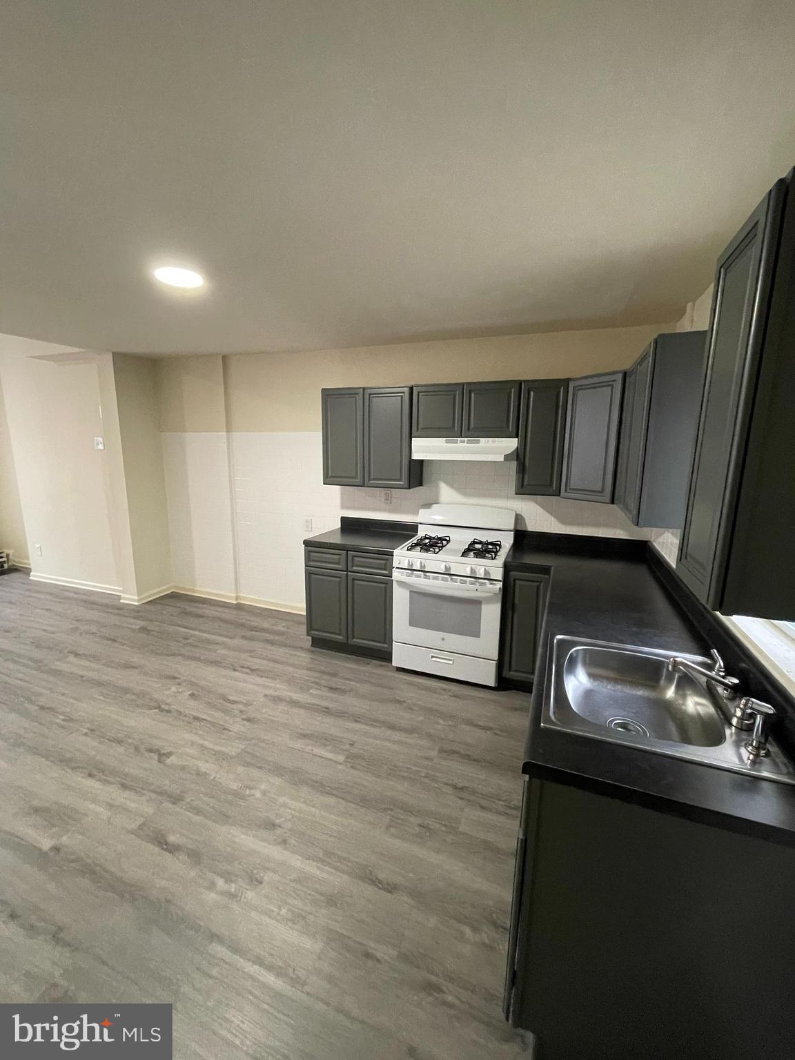 2441 North 5th Street Philadelphia, PA 19133 - Photo 4 of 18 a kitchen with a stove a microwave and a sink