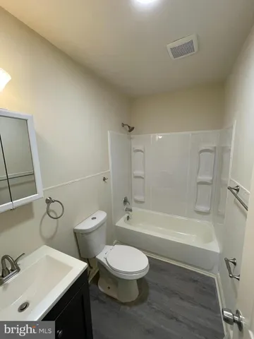 a bathroom with a toilet a sink and bathtub