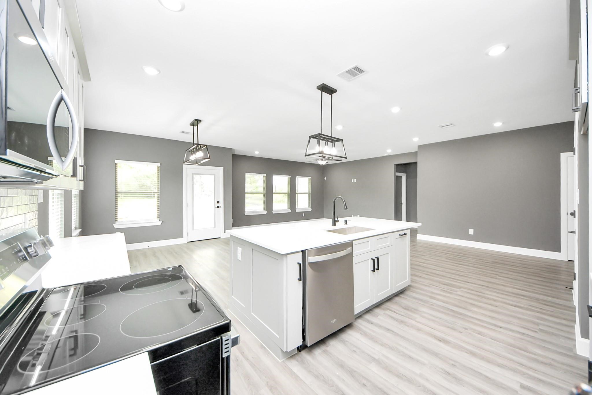 601 Lily Street Prairie View, TX 77484 - Photo 13 of 14 a large white kitchen with wooden floor