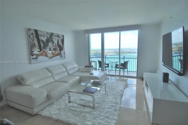 a living room with furniture and a large window