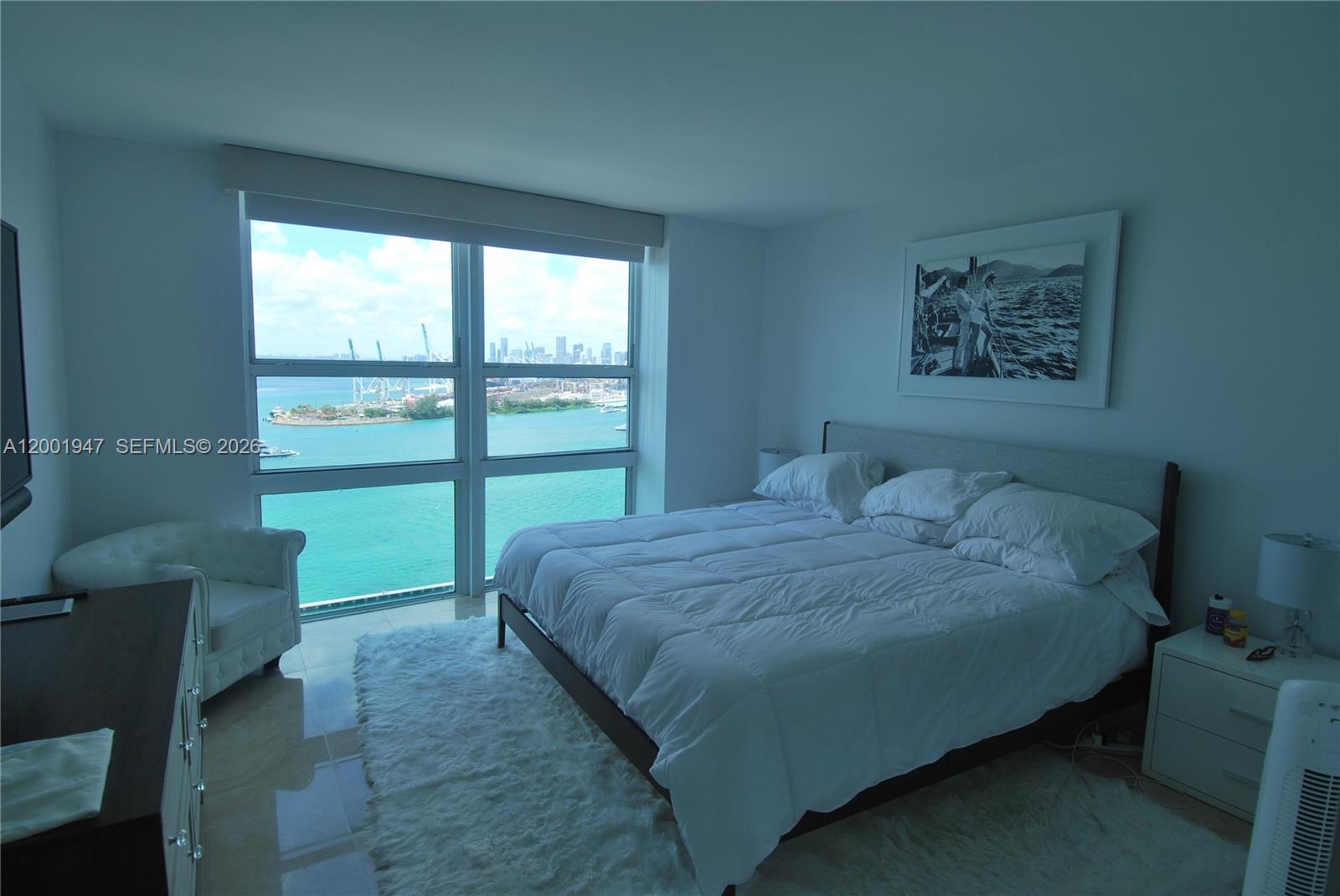 90 Alton Road, Unit 2606 Miami Beach, FL 33139 - Photo 2 of 13 a bedroom with a bed and a large window
