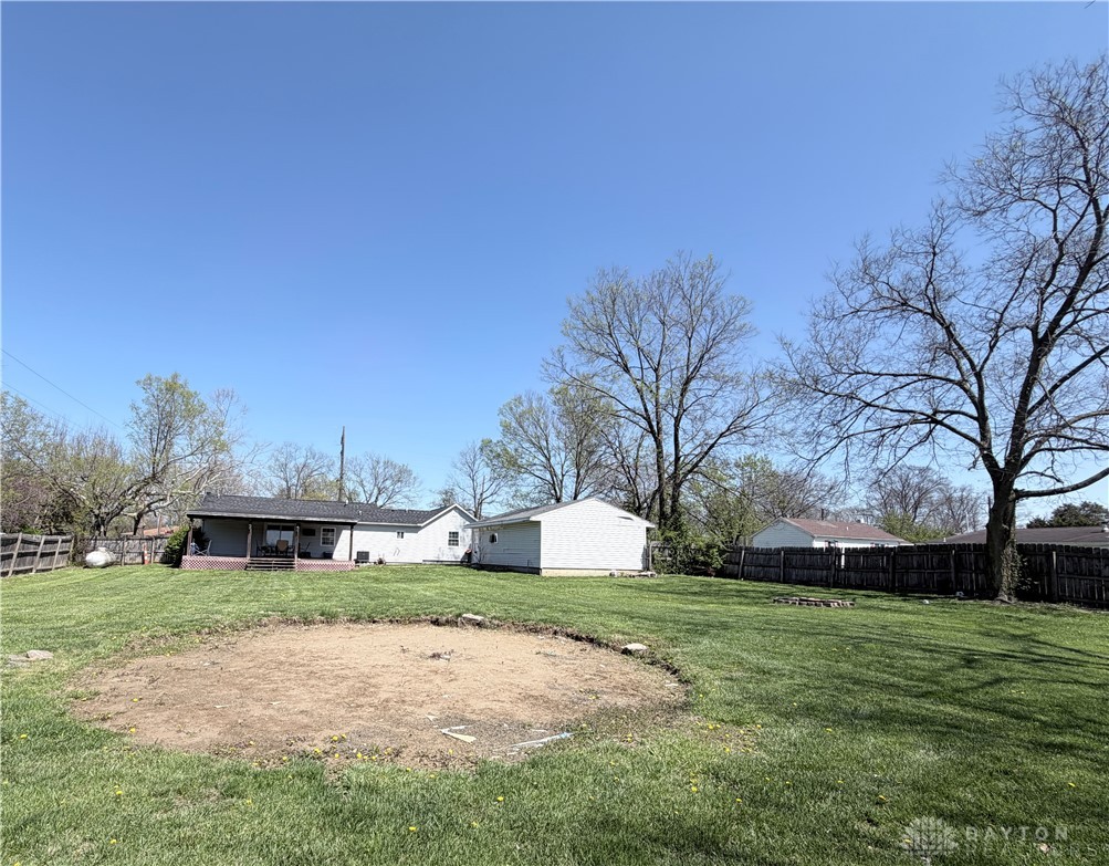 6800 Farmington Road Miamisburg, OH 45342 - Photo 29 of 32 This spacious yard features a lush lawn and a private back porch, perfect for outdoor enjoyment.