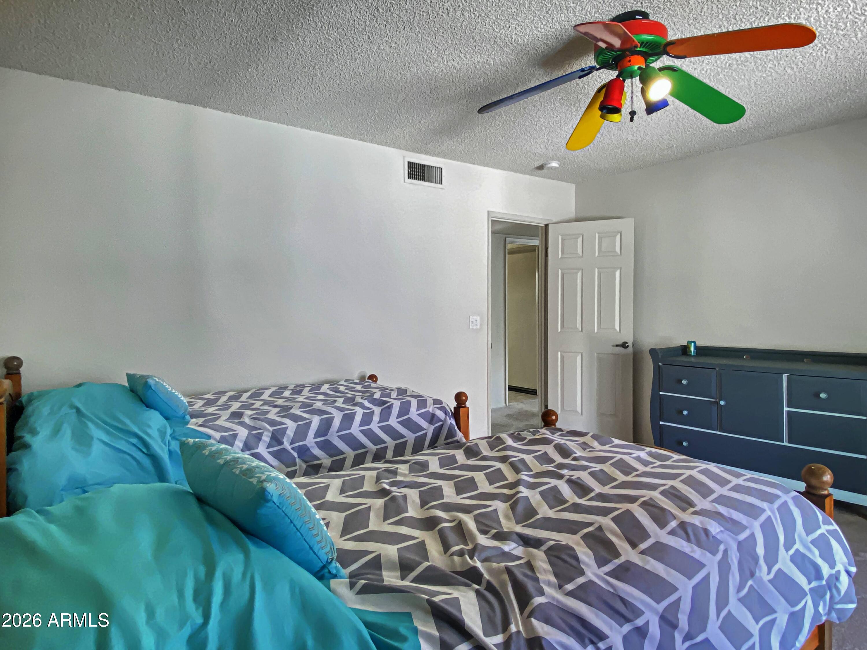 550 Barcelona Road Sedona, AZ 86336 - Photo 21 of 32 a bedroom with a bed and a chandelier