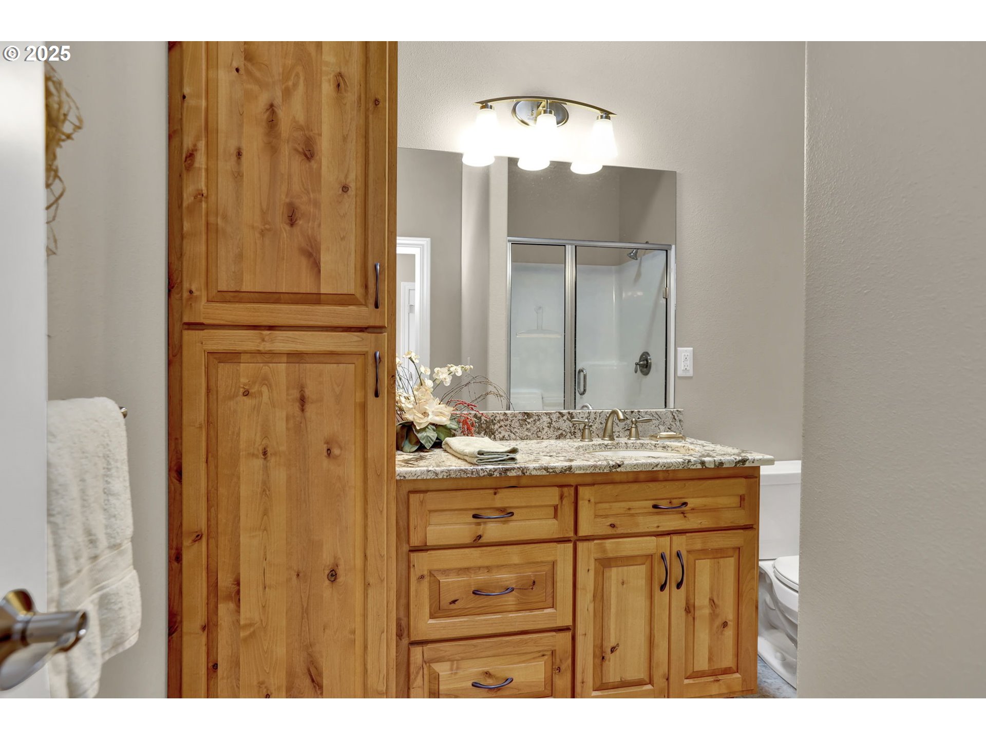 485 Andrews Road Yoncalla, OR 97499 - Photo 21 of 46 a bathroom with a granite countertop sink and a mirror