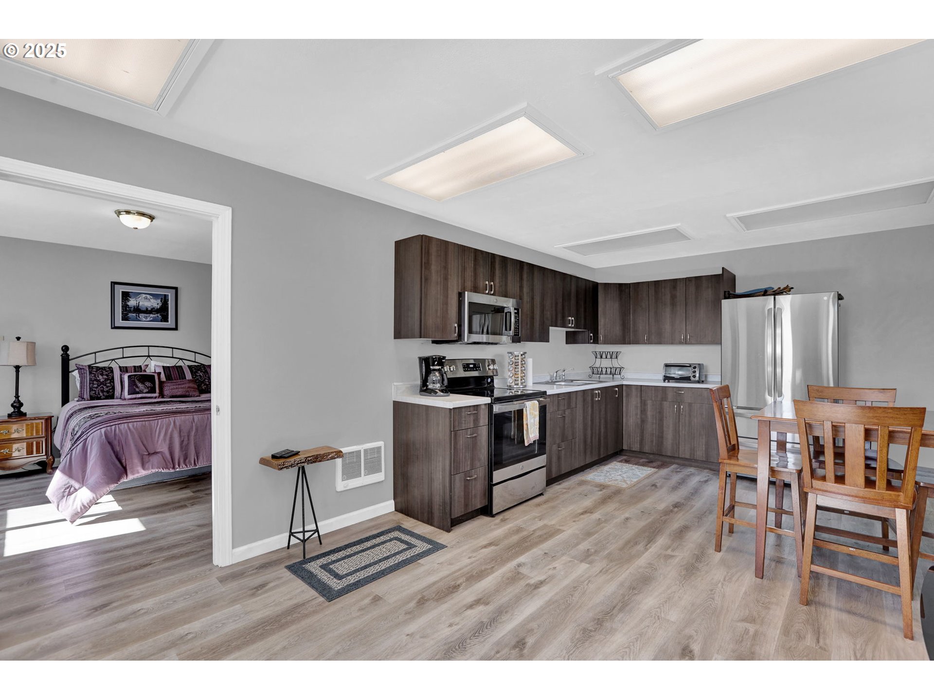 485 Andrews Road Yoncalla, OR 97499 - Photo 32 of 46 a kitchen with stainless steel appliances wooden floors and wooden cabinets