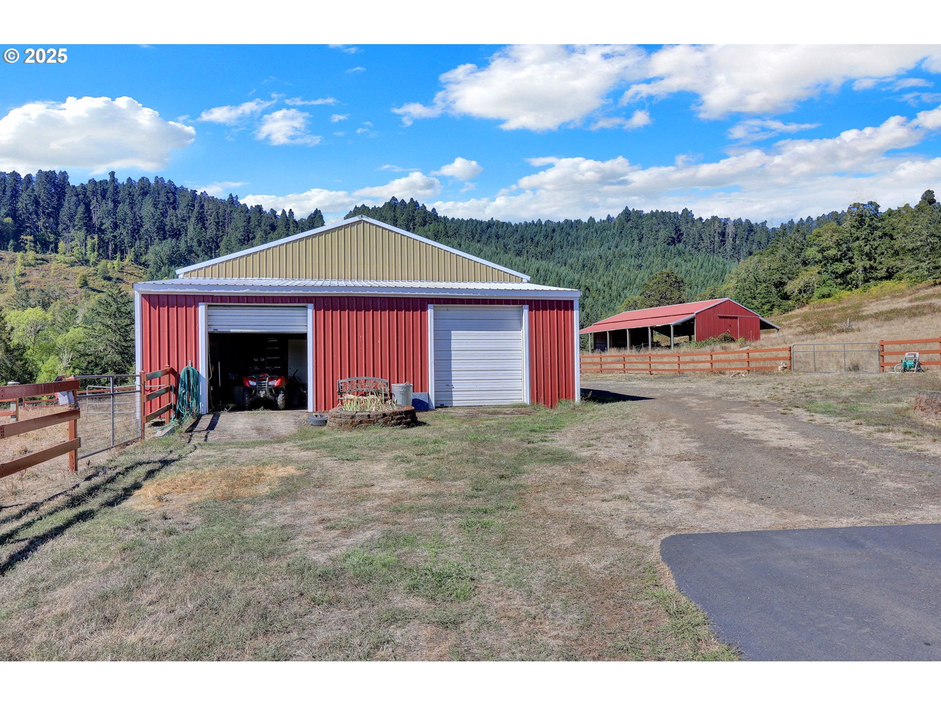 485 Andrews Road Yoncalla, OR 97499 - Photo 39 of 46 a view of a barn with a yard and large trees