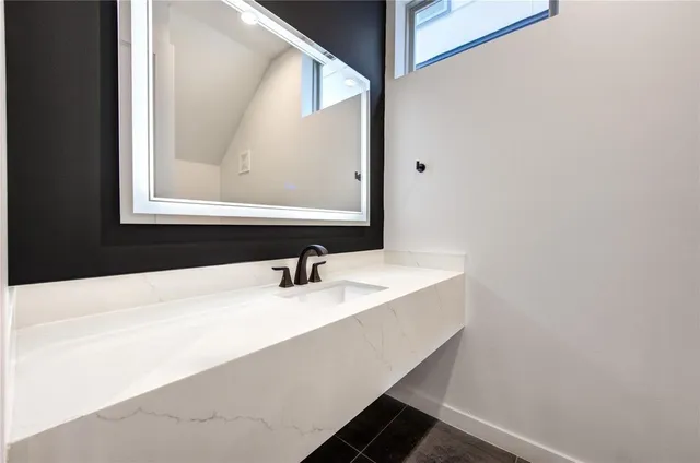 a bathroom with a sink and a mirror