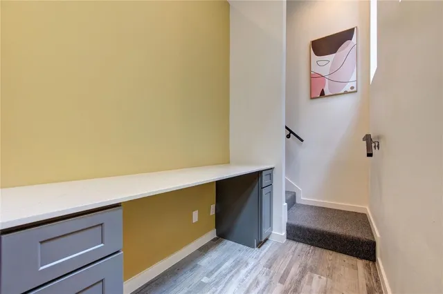 a room with walk in closet and wooden floor