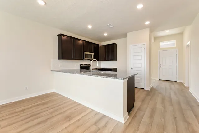 a kitchen with stainless steel appliances a refrigerator and a stove top oven