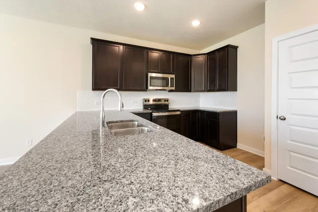 a kitchen with a sink and a refrigerator