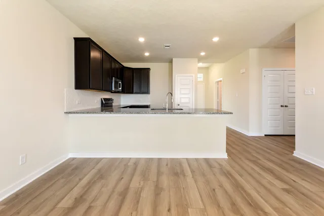 a view of kitchen with kitchen island microwave and stove