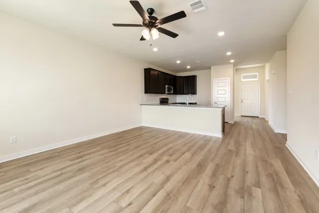 a view of a kitchen with a dishwasher and wooden floor