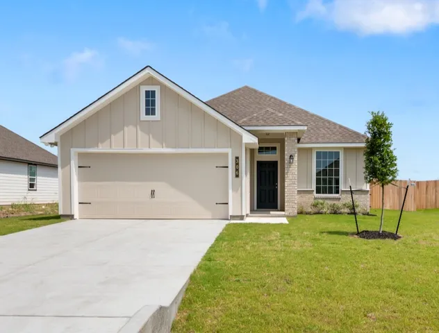 a front view of a house with a yard and table