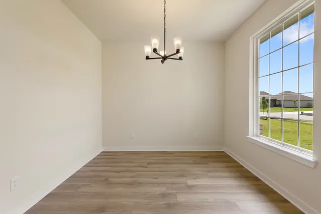 a view of a room with a window and wooden floor