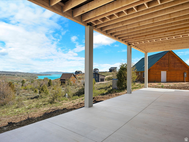 1159 North Broad Hollow Road Garden City, UT 84028 - Photo 14 of 55 Covered patio with a concrete slab, exposed wood joists, and structural support posts