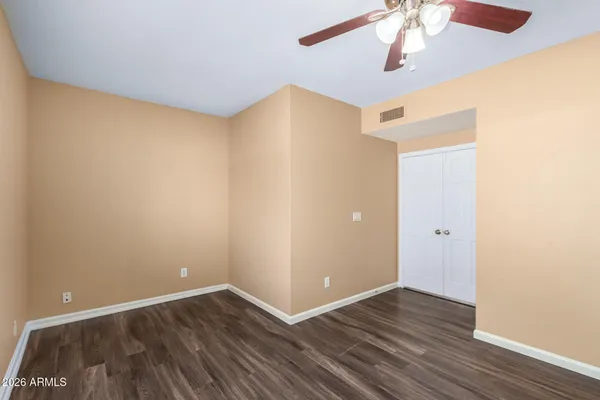 a view of an empty room with wooden floor