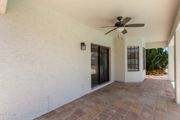 a view of empty room with ceiling fan and window