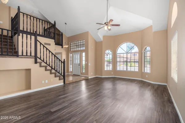 a view of an entryway with wooden floor fan and a window