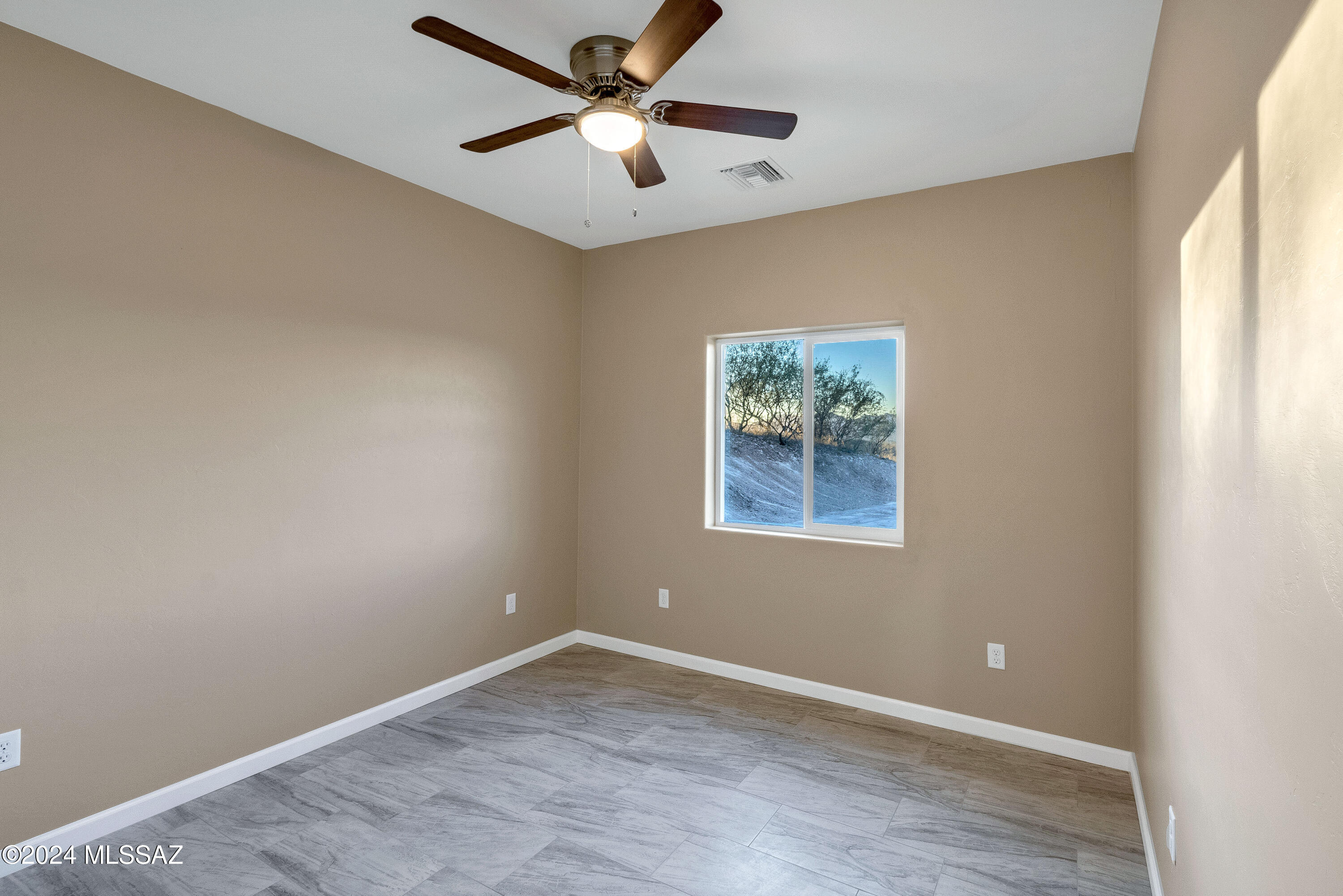 221 Paseo Mascota Rio Rico, AZ 85648 - Photo 34 of 45 an empty room with a window and a fan
