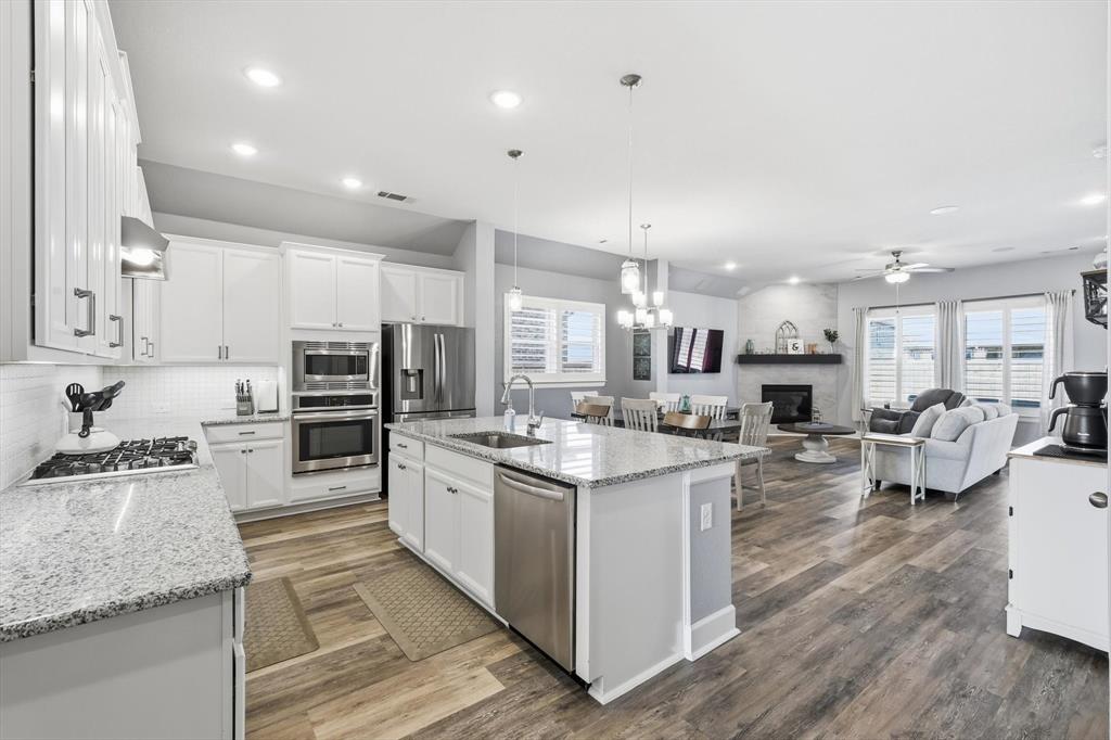 1701 Shetland Road Aubrey, TX 76227 - Photo 4 of 34 Luxury vinyl flooring throughout the common areas of the home, and custom plantation shutters elevate your views both inside and out!