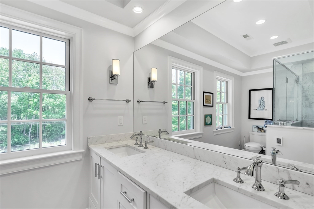 34 Solomon Pierce Road Lexington, MA 02420 - Photo 25 of 42 a bathroom with double vanity sinks and a mirror