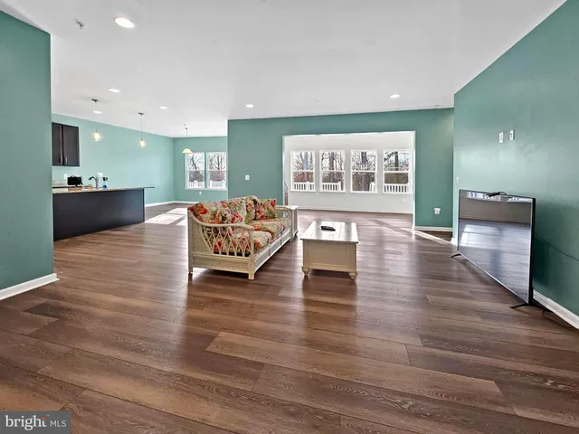 a living room with furniture and kitchen view