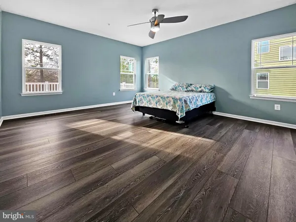 a spacious bedroom with a bed and a window