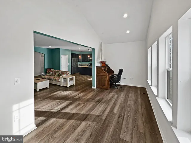 a view of a living room and bedroom with furniture