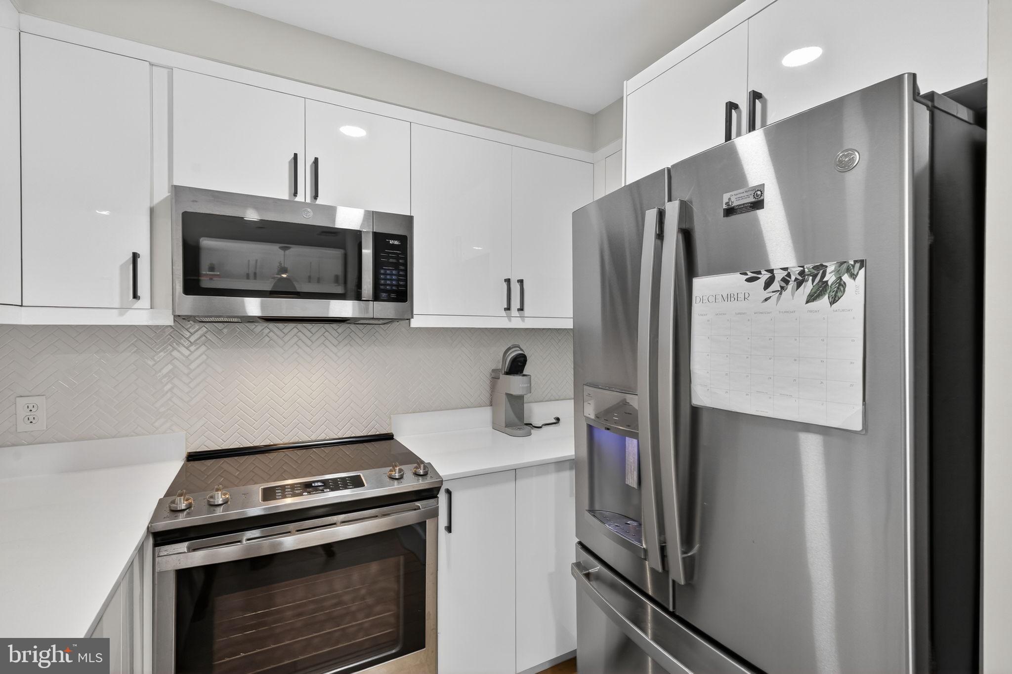 919 12th Street Northeast, Unit 305 Washington, DC 20002 - Photo 11 of 31 a kitchen with stainless steel appliances a refrigerator stove and microwave
